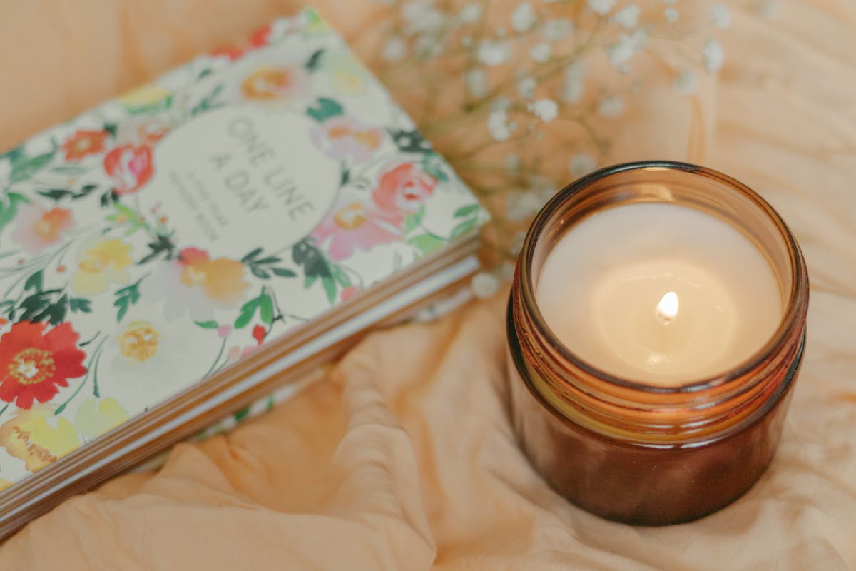 An open journal beside a softly-lit candle — the kind of private space we wanted Arcov to feel like