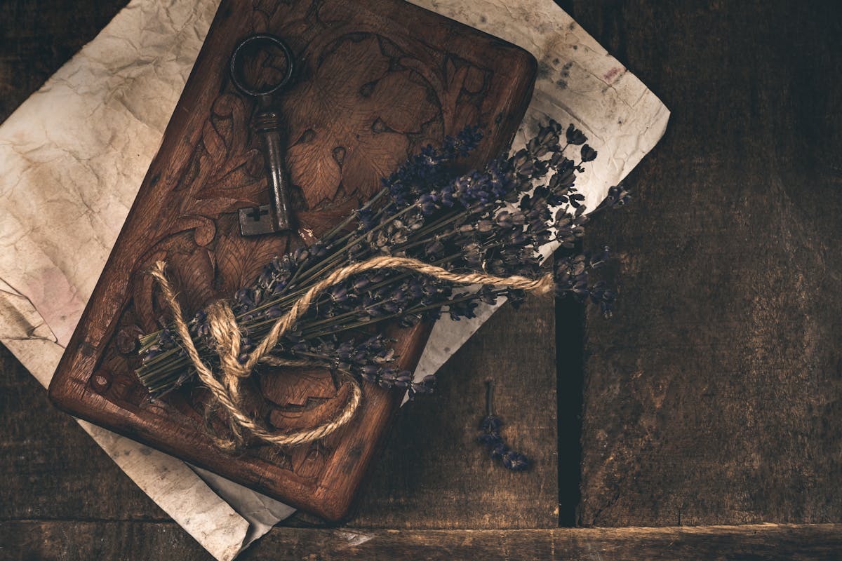 An antique key resting on dried lavender — the question of what's worth locking, and from whom.